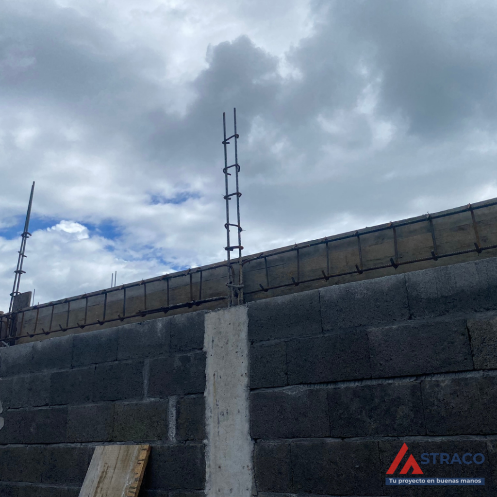 Reinforced concrete ring beam with steel rebar on top of block walls for structural stability in Panama